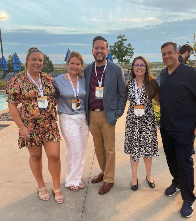 A group of people posing for a photo
Description automatically generated