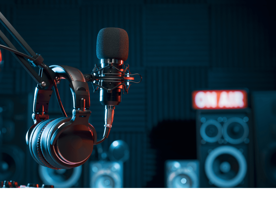 Professional podcast studio with microphone and headphones for dynamic audio ad insertion publishers