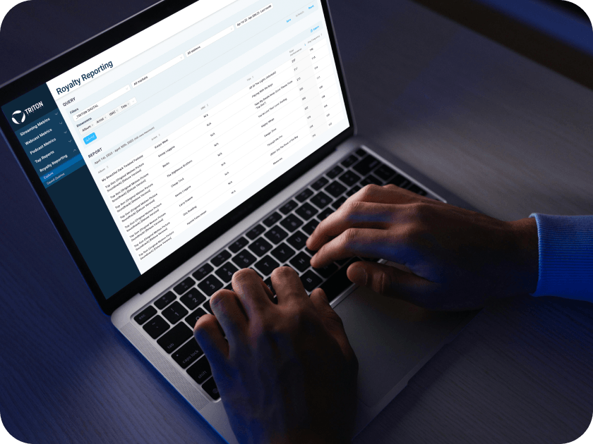 Laptop displaying Triton Royalty Reporting dashboard for automated report management